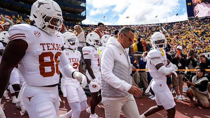 Sep 7, 2024; Ann Arbor, Michigan, USA; Texas head coach Steve Sarkisian and the Texas players take the field for warm ups at Michigan Stadium. Mandatory Credit: Junfu Han-USA TODAY Network via Imagn Images