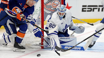 Jan 2, 2025; Elmont, New York, USA; Toronto Maple Leafs goaltender Joseph Woll (60) makes a save against New York Islanders center Casey Cizikas (53) during the second period at UBS Arena. Mandatory Credit: Brad Penner-Imagn Images