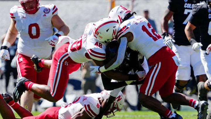 Sep 9, 2023; Boulder, Colorado, USA; Nebraska Cornhuskers defensive back Omar Brown (12) and linebacker MJ Sherman (48) tackle Colorado Buffaloes cornerback Travis Hunter (12) in the second quarter at Folsom Field.