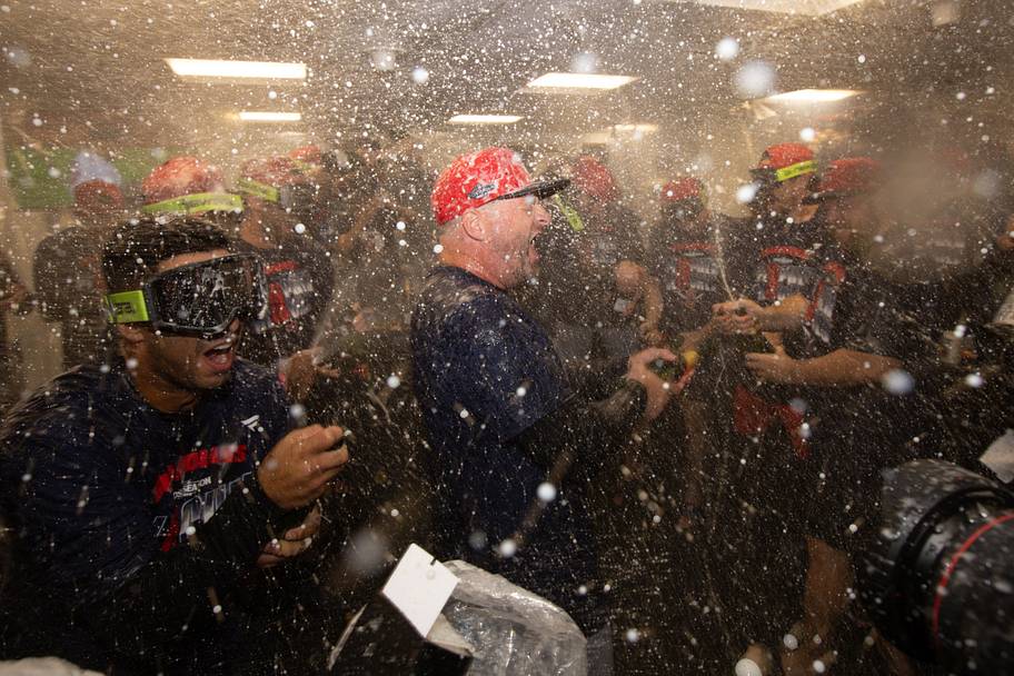 Cleveland Guardians players celebrate in the clubhouse