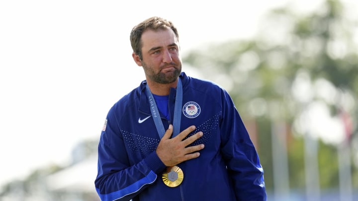 Aug 4, 2024; Saint-Quentin-en-Yvelines, France; Scottie Scheffler of Team United States reacts after winning the gold medal in menís individual stroke play during the Paris 2024 Olympic Summer Games at Le Golf National. Mandatory Credit: Michael Madrid-USA TODAY Sports