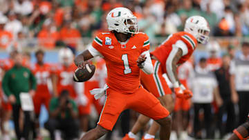 Dec 28, 2024; Orlando, FL, USA; Miami Hurricanes quarterback Cam Ward (1) drops back to pass against the Iowa State Cyclones in the first quarter during the Pop Tarts bowl at Camping World Stadium. Mandatory Credit: Nathan Ray Seebeck-Imagn Images