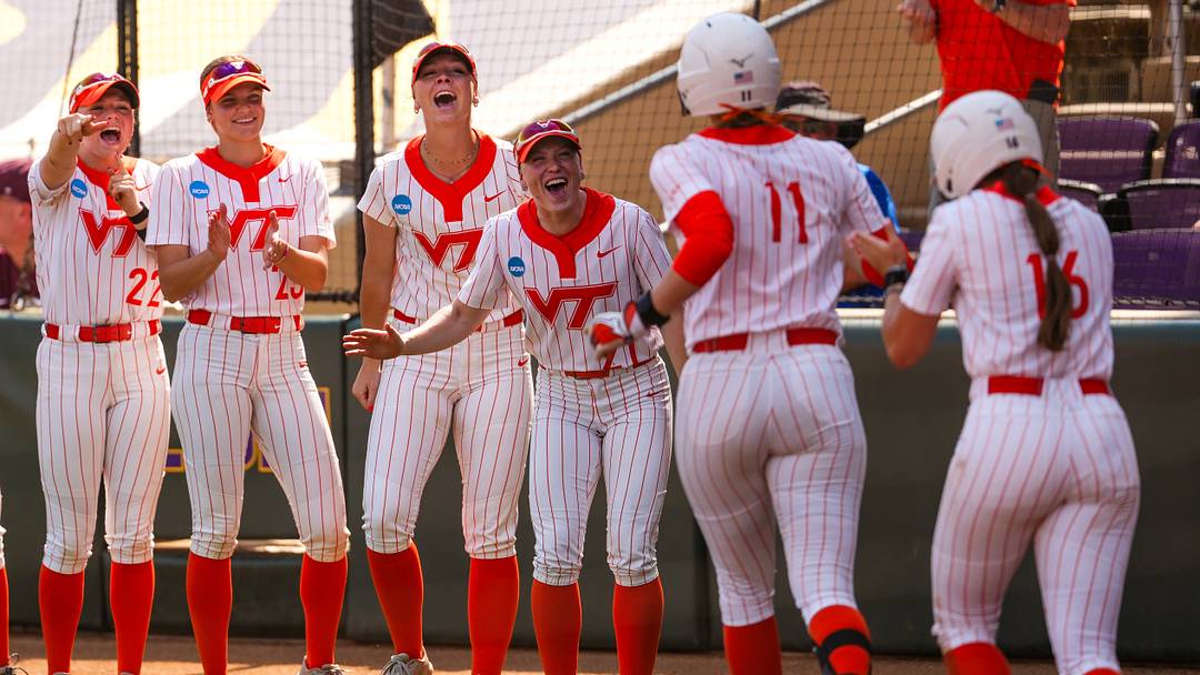 The Hokies celebrate outside of their dugout.