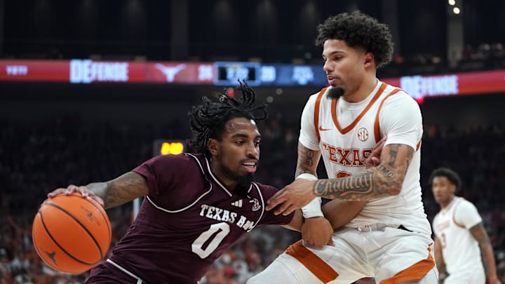 Jan 17, 2026; Austin, Texas, USA; Texas A&M Aggies guard Marcus Hill (0) moves the ball against Texas Longhorns guard Jordan Pope (0) during the first half at Moody Center. Mandatory Credit: Dustin Safranek-Imagn Images