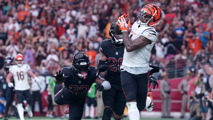 Oct 8, 2023; Glendale, Arizona, USA; Cincinnati Bengals wide receiver Ja'Marr Chase (1) catches a touchdown pass against Arizona Cardinals safety K'Von Wallace (22) and Arizona Cardinals cornerback Marco Wilson (20) during the second half at State Farm Stadium. Mandatory Credit: Joe Camporeale-USA TODAY Sports