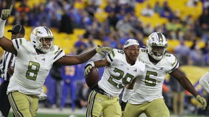 Oct 1, 2022; Pittsburgh, Pennsylvania, USA; Georgia Tech Yellow Jackets defensive lineman Makius Scott (8) and defensive back Clayton Powell-Lee (29) and defensive lineman Keion White (6) celebrate fumble recovery by Powell-Lee against the Pittsburgh Panthers during the fourth quarter at Acrisure Stadium. Georgia Tech won 26-21. Mandatory Credit: Charles LeClaire-USA TODAY Sports