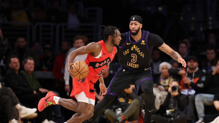 Jan 9, 2024; Los Angeles, California, USA; Toronto Raptors guard Immanuel Quickley (5) attacks the floor against Los Angeles Lakers center Anthony Davis (3).