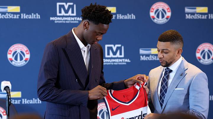 Jun 25, 2026; Washington, DC, USA; Washington Wizards first round draft pick and number one overall pick AJ Dybantsa (left) poses for a photo with his jersey and Wizards general manager Will Dawkins (right) during a press conference at InterContinental Hotel. Mandatory Credit: Amber Searls-Imagn Images