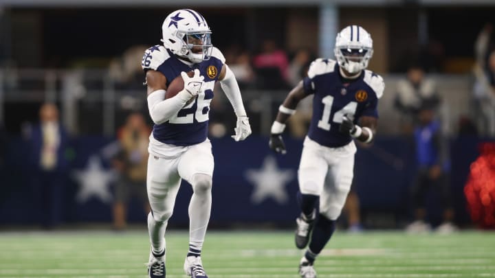 Nov 23, 2023; Arlington, Texas, USA; Dallas Cowboys cornerback DaRon Bland (26) returns an interception for a touchdown in the fourth quarter against the Washington Commanders at AT&T Stadium. Mandatory Credit: Tim Heitman-USA TODAY Sports