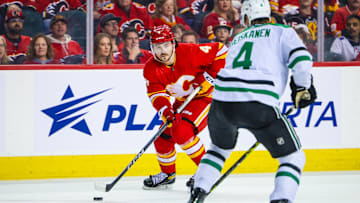 Nov 30, 2023; Calgary, Alberta, CAN; Calgary Flames defenseman Rasmus Andersson (4) controls the puck against the Dallas Stars during the overtime period at Scotiabank Saddledome. Mandatory Credit: Sergei Belski-Imagn Images