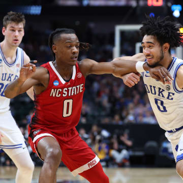 Mar 31, 2024; Dallas, TX, USA; Duke Blue Devils guard Jared McCain (0) controls the ball against North Carolina State Wolfpack guard DJ Horne (0) in the first half in the finals of the South Regional of the 2024 NCAA Tournament at American Airline Center. Mandatory Credit: Kevin Jairaj-USA TODAY Sports