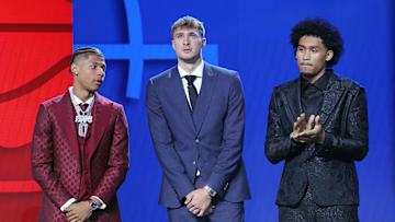 Jeremiah Fears, Cooper Flagg, and Dylan Harper stand on stage before the 2025 NBA Draft.