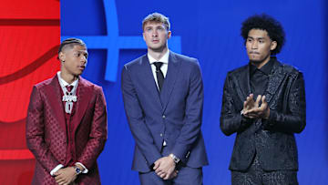 Top NBA Draft prospects Jeremiah Fears, Cooper Flagg, and Dylan Harper stand on stage before the 2025 NBA Draft