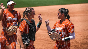 Texas Longhorns catcher Reese Atwood (14) greets pitcher Citlaly Gutierrez (77) after striking out a Texas A&M batter during the NCAA Regional game at Red & Charline McCombs Field on Saturday, May 20, 2023 in Austin.