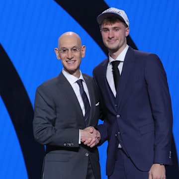 Cooper Flagg poses with NBA commissioner Adam Silver after being selected as first overall by the Dallas Mavericks in the first round of the 2025 NBA Draft.