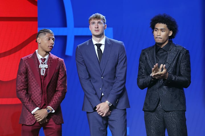 Jeremiah Fears, Cooper Flagg, and Dylan Harper stand on stage before the 2025 NBA Draft at Barclays Center. 