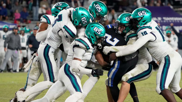 Ramsay's Ashton Ashford (2) is swarmed by Gulf Shores High tacklers during the 5A AHSAA State Championship Game 