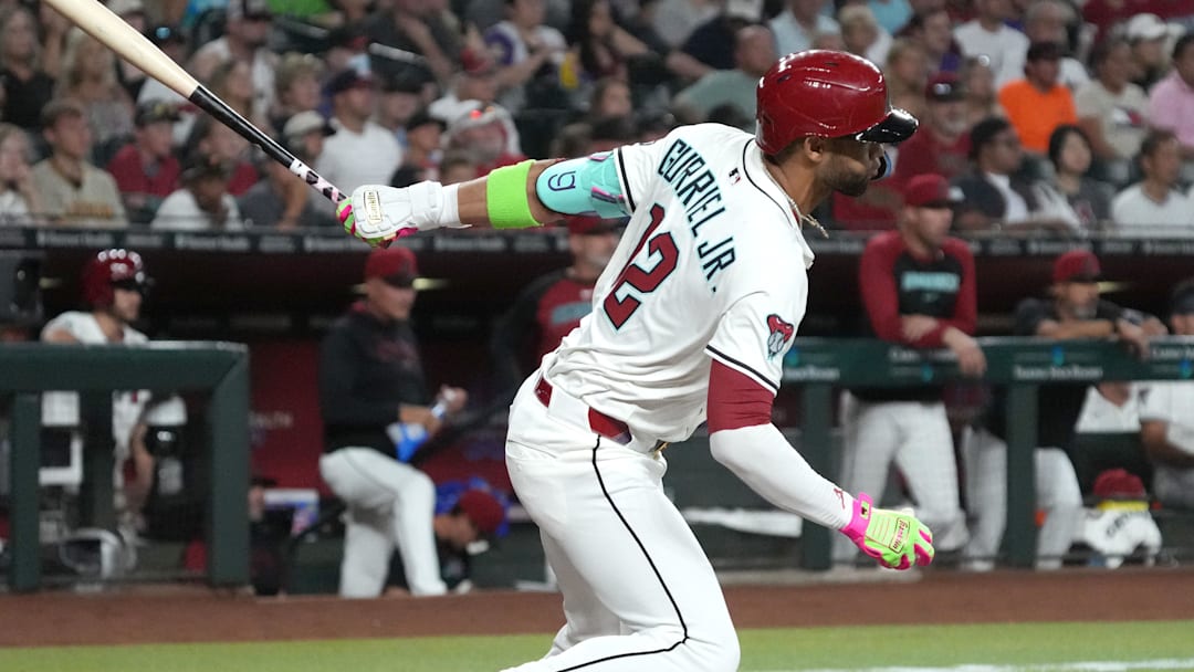Aug 4, 2025; Phoenix, Arizona, USA; Arizona Diamondbacks outfielder Lourdes Gurriel Jr. (12) hits an RBI single against the San Diego Padres in the first inning at Chase Field. Mandatory Credit: Rick Scuteri-Imagn Images