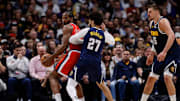 Los Angeles Clippers forward Kawhi Leonard (2) controls the ball as Denver Nuggets guard Jamal Murray (27) guards and center Nikola Jokic (15) defends in the third quarter during game two of first round for the 2025 NBA Playoffs at Ball Arena. Mandatory Credit: Isaiah J. Downing-Imagn Images