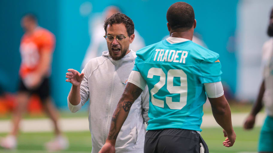 Miami Dolphins head coach Mike McDaniel talks to safety Dante Trader Jr. (29) during mandatory minicamp at Hard Rock Stadium.  | Sam Navarro-Imagn Images