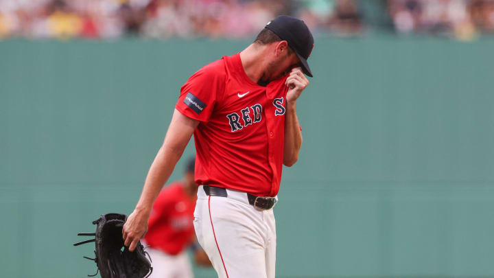 Jul 12, 2024; Boston, Massachusetts, USA; Boston Red Sox starting pitcher Cooper Criswell (64) reacts during the first inning against the Kansas City Royals at Fenway Park. Mandatory Credit: Paul Rutherford-USA TODAY Sports