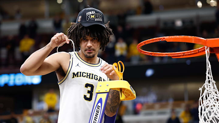 Mar 29, 2026; Chicago, IL, USA; Michigan Wolverines guard Elliot Cadeau (3) cuts the net after defeating Tennessee Volunteers in an Elite Eight game of the Midwest Regional of the men's 2026 NCAA Tournament at United Center. Mandatory Credit: Kamil Krzaczynski-Imagn Images