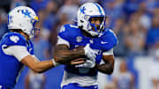 Sep 13, 2025; Lexington, Kentucky, USA; Kentucky Wildcats quarterback Cutter Boley (left) hands the ball off to running back Seth McGowan (3) during the first quarter against the Eastern Michigan Eagles at Kroger Field. Mandatory Credit: Jordan Prather-Imagn Images