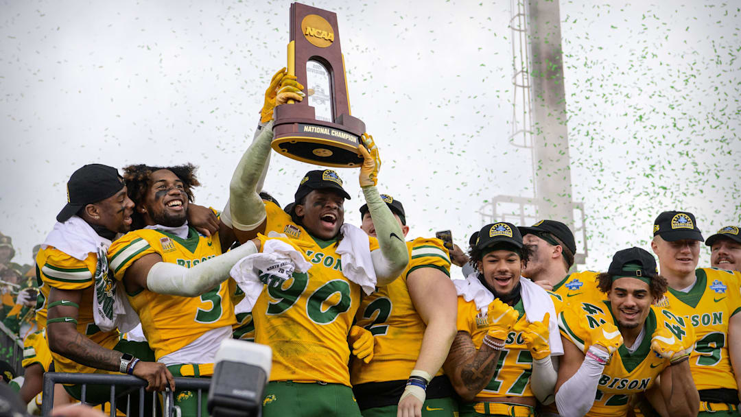 The North Dakota State Bison celebrate with the championship trophy after the win over the Montana State Bobcats