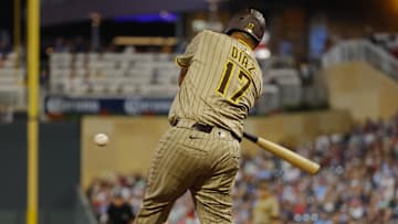Aug 30, 2025; Minneapolis, Minnesota, USA; San Diego Padres catcher Elias Diaz (17) hits a two-run home run against the Minnesota Twins in the seventh inning at Target Field. Mandatory Credit: Bruce Kluckhohn-Imagn Images