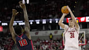 Wisconsin forward Nolan Winter (31) hits a three-point basket over Detroit Mercy guard Nate Johnson (10) during the second half of their game Sunday, December 22, 2024 at the Kohl Center in Madison, Wisconsin. Wisconsin beat Detroit Mercy 76-53.