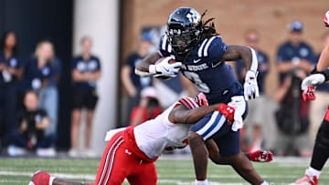 Sep 14, 2024; Logan, Utah, USA;  Utah State Aggies running back Rahsul Faison (3) is brought down by Utah Utes linebacker Levani Damuni (3) after a short gain in the second half at Merlin Olsen Field at Maverik Stadium. Mandatory Credit: Jamie Sabau-Imagn Images