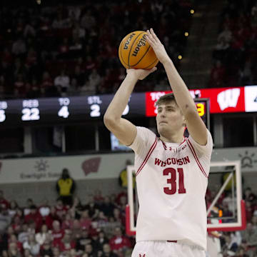 Wisconsin forward Nolan Winter (31) hits a three-point basket over Detroit Mercy guard Nate Johnson (10) during the second half of their game Sunday, December 22, 2024 at the Kohl Center in Madison, Wisconsin. Wisconsin beat Detroit Mercy 76-53.