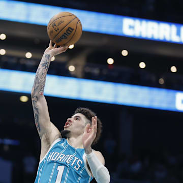 Oct 26, 2024; Charlotte, North Carolina, USA; Charlotte Hornets guard LaMelo Ball (1) shoots over Miami Heat center Bam Adebayo (13) during the second half at Spectrum Center. Mandatory Credit: Nell Redmond-Imagn Images