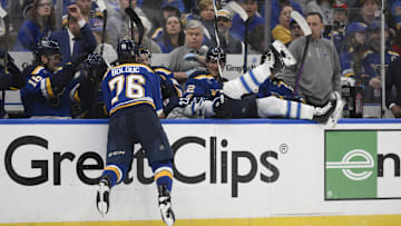 Apr 27, 2025; St. Louis, Missouri, USA; St. Louis Blues right wing Zack Bolduc (76) finishes a check on Winnipeg Jets center Mason Appleton (22) during the third period in game four of the first round of the 2025 Stanley Cup Playoffs at Enterprise Center. Mandatory Credit: Jeff Le-Imagn Images