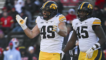 Nov 23, 2024; College Park, Maryland, USA;  Iowa Hawkeyes defensive lineman Ethan Hurkett (49) celebrates after tackling Maryland Terrapins running back Nolan Ray (not pictured) behind the line of scrimmage during the second  half at SECU Stadium. Mandatory Credit: Tommy Gilligan-Imagn Images
