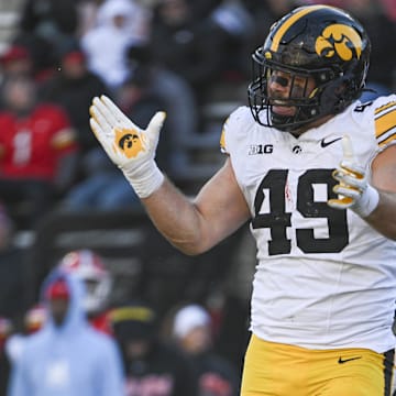 Nov 23, 2024; College Park, Maryland, USA;  Iowa Hawkeyes defensive lineman Ethan Hurkett (49) celebrates after tackling Maryland Terrapins running back Nolan Ray (not pictured) behind the line of scrimmage during the second  half at SECU Stadium. Mandatory Credit: Tommy Gilligan-Imagn Images