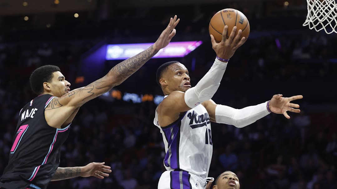 Dec 6, 2025; Miami, Florida, USA;  Sacramento Kings guard Russell Westbrook (18) shoots around Miami Heat center Kel'el Ware (7) during the second half at Kaseya Center. Mandatory Credit: Rhona Wise-Imagn Images