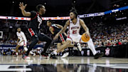 Houston Cougars guard Emanuel Sharp (21) dribbles the ball while defended by Texas Tech Red Raiders guard Lamar Washington (2)
