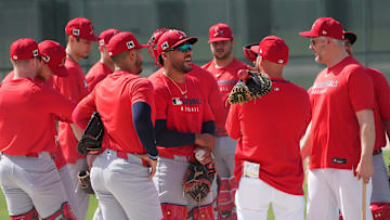 Feb 12, 2025; Jupiter, FL, USA;  St. Louis Cardinals catchers and coaches gather for a meeting during Spring Training. Mandatory Credit: Jim Rassol-Imagn Images