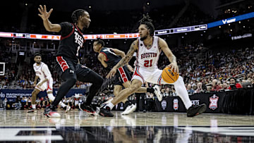 Houston Cougars guard Emanuel Sharp (21) dribbles the ball while defended by Texas Tech Red Raiders guard Lamar Washington (2)