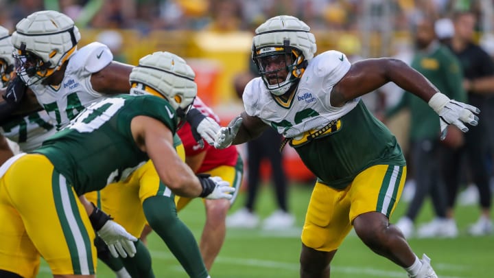 Green Bay Packers left tackle Rasheed Walker (63) blocks defensive lineman Lukas Van Ness (90) at Family Night.