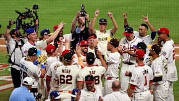 National League designated hitter Kyle Schwarber (12) of the Philadelphia Phillies celebrates with his teammates after hitting in the swing-off after the 2025 MLB All Star Game ended in a tie at Truist Park on Tuesday.