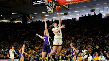 Iowa center Ava Heiden (5) shoots the ball as Evansville forward Georgia Ferguson (2) defends Nov. 9, 2025 during a women’s basketball game at Carver-Hawkeye Arena in Iowa City, Iowa.
