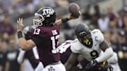 Texas A&M Aggies quarterback Haynes King (13) passes against the rush of Appalachian State Mountaineers linebacker Nick Hampton (9) in the second quarter  at Kyle Field.