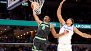 Jan 5, 2025; Memphis, Tennessee, USA; North Texas Mean Green forward Brenen Lorient (6) dunks the ball against Memphis Tigers forward Nicholas Jourdain (2) during the second half at FedExForum. Mandatory Credit: Wesley Hale-Imagn Images