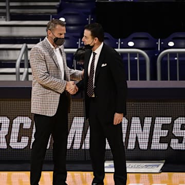 Mar 20, 2021; Indianapolis, Indiana, USA; Alabama Crimson Tide head coach Nate Oats (left) greets Iona Gaels head coach Rick Pitino after their game during the first round of the 2021 NCAA Tournament at Hinkle Fieldhouse. Mandatory Credit: Marc Lebryk-Imagn Images