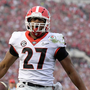 Jan 1, 2018; Pasadena, CA, USA; Georgia Bulldogs running back Nick Chubb (27) celebrates after scoring on a 50-yard touchdown run in the third quarter against the Oklahoma Sooners in the 2018 Rose Bowl college football playoff semifinal game at Rose Bowl Stadium. Georgia defeated Oklahoma 54-48 in two overtimes. Mandatory Credit: Kirby Lee-Imagn Images