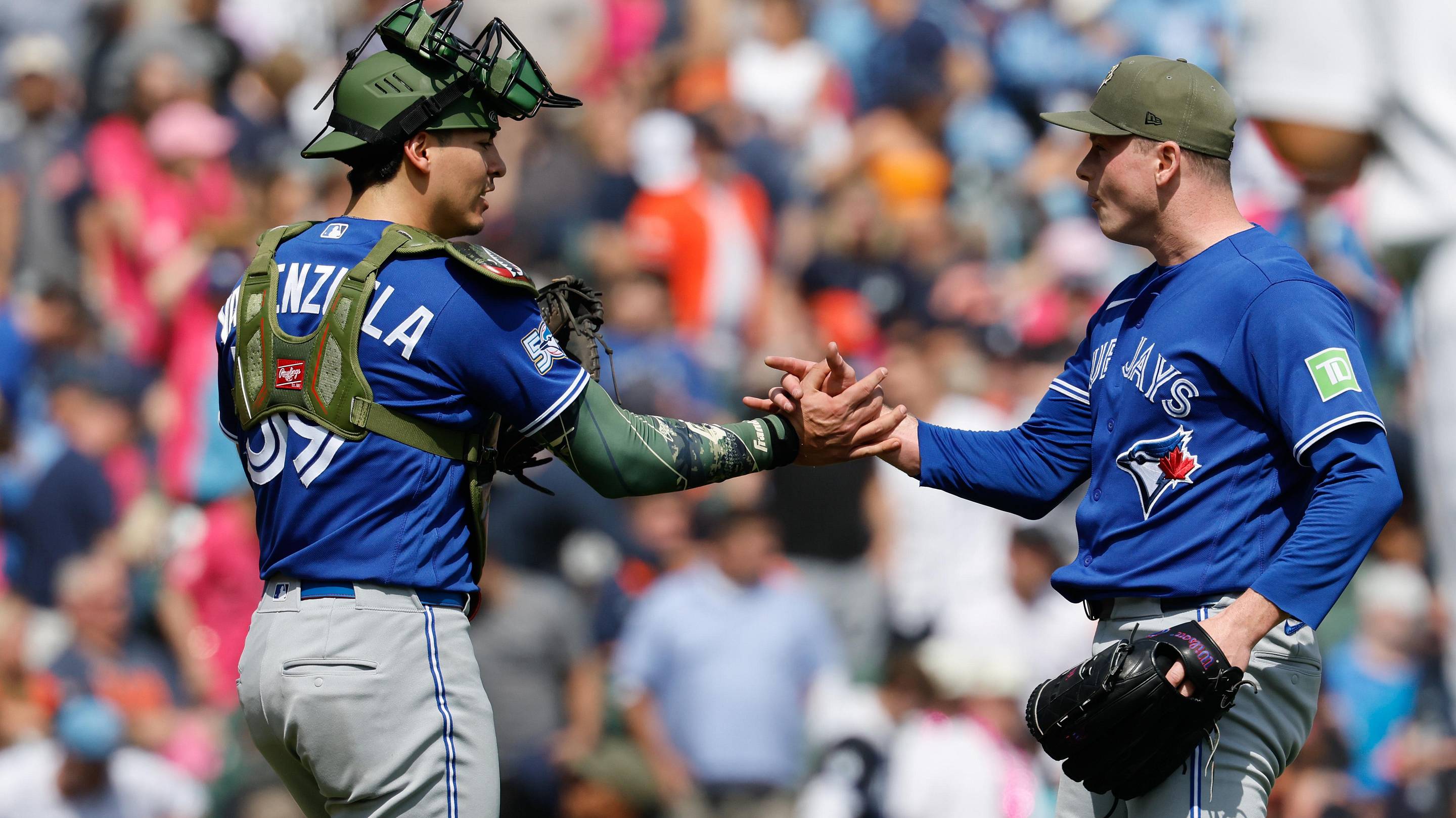 May 16, 2026; Detroit, Michigan, USA; Toronto Blue Jays catcher Brandon Valenzuela (59) and pitcher Louis Varland (77) celebrate after defeating the Detroit Tigers at Comerica Park.
