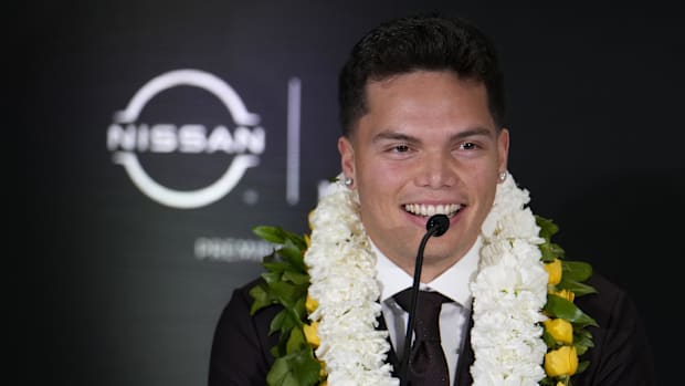 Oregon Ducks quarterback Dillon Gabriel speaks on stage during a press conference before the 2024 Heisman Trophy Presentation
