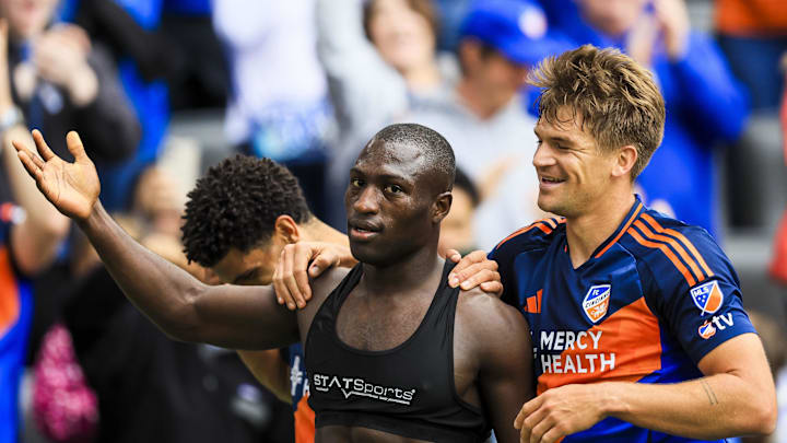 Apr 26, 2025; Cincinnati, Ohio, USA; FC Cincinnati forward Kevin Denkey (9) reacts with defender Nick Hagglund (4) after scoring a goal against Sporting Kansas City in the second half at TQL Stadium. Mandatory Credit: Katie Stratman-Imagn Images